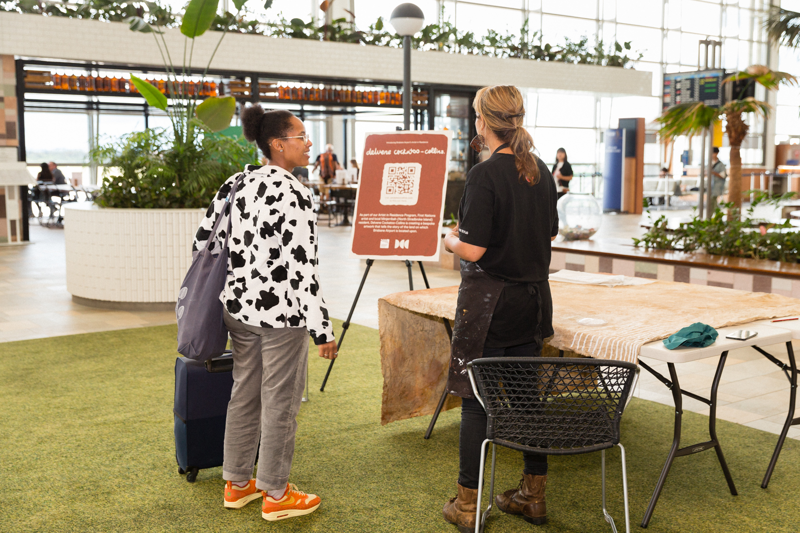 Delvene talking to a lady at the International Terminal